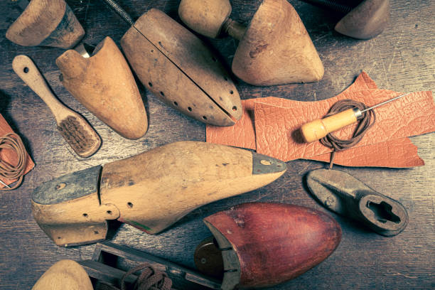 istock Vintage cobbler workplace with tools, laces and shoes. 1351684835