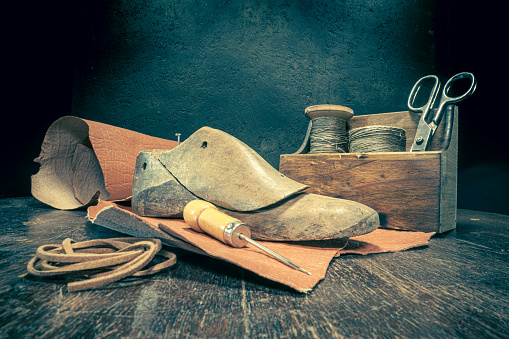 Small shoemaker workshop with tools, rules, leather and strap. Small shoemaker workshop