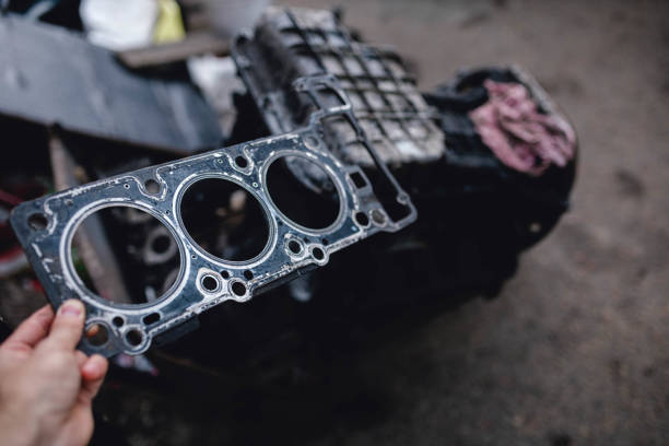 replacing the cylinder block gasket of a three-cylinder engine. stock photo
