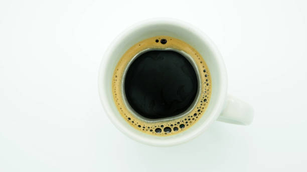 istock cup of coffee top view white background. 1351686600