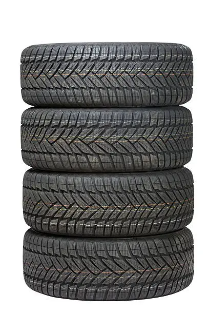 Photo of Four black tires stacked on top of one another