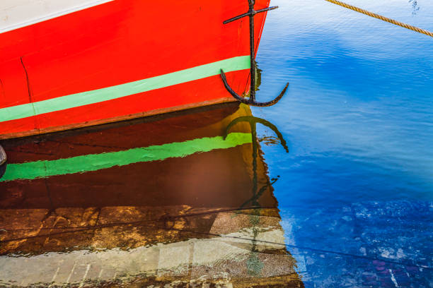 Colorful Marina Red Boat Waterfront Reflections Inner Harbor Honfluer France.  Honfluer is famous for its reflections, which inspired Monet