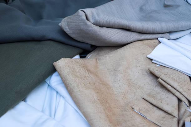 istock Detailed close up view on samples of cloth and fabrics in different colors found at a fabrics market 1351693326
