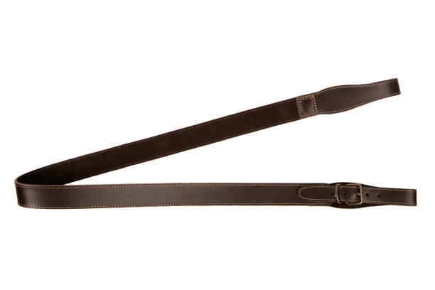 istock Brown leather shoulder strap for a gun isolated on white background 1351695052