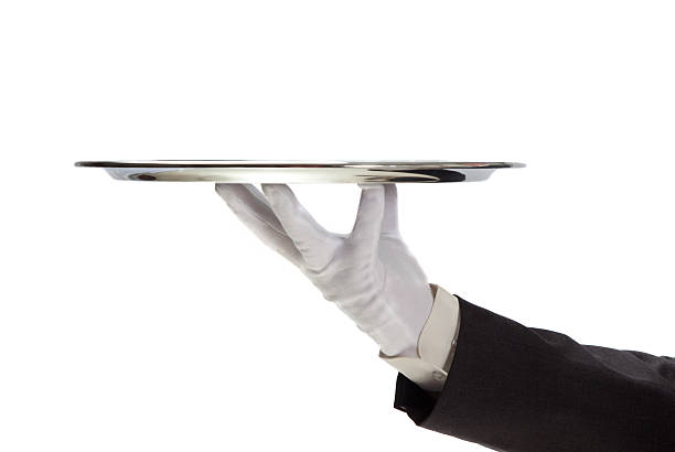 Serving Butler holding empty silver tray in gloved hand. formal glove stock pictures, royalty-free photos & images