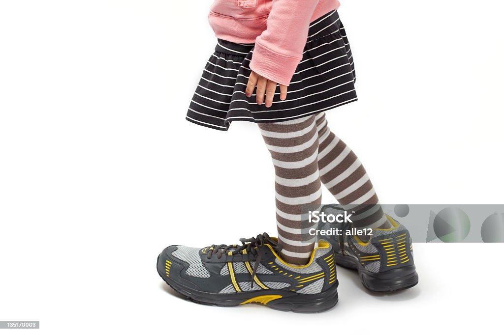 Little feet in big shoes Little feet in big shoes. Beauty Stock Photo