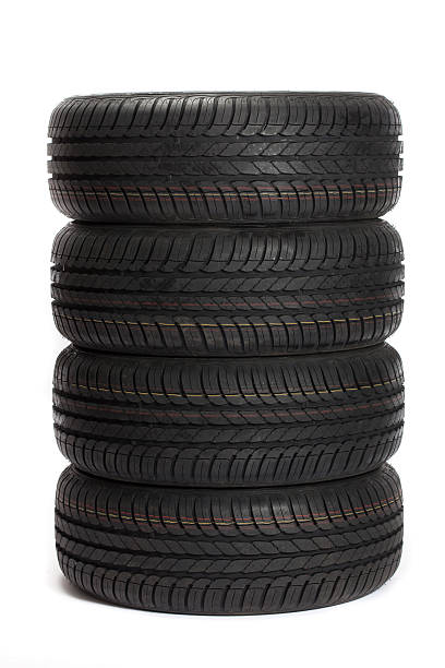 Four black car tires stacked on top of one another Brand new tires stacked up and isolated on white background. http://www.tomasworks.com/dusan/CARS&TIRES.jpg  stacking stock pictures, royalty-free photos & images