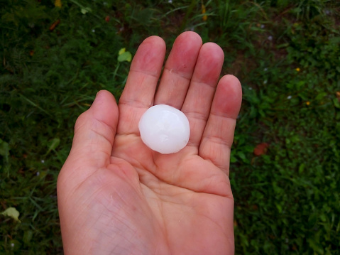 A large hailstone in your hand after a summer hurricane.