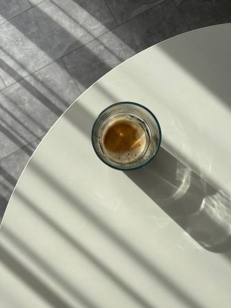 black coffee in a glass on a white table top view