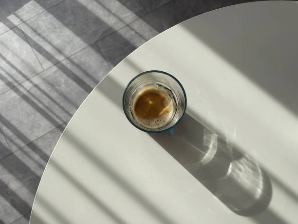 black coffee in a glass on a white table top view