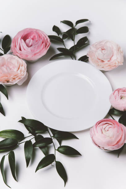 istock top view of beautiful table setting with flowers and white plate 1351709952