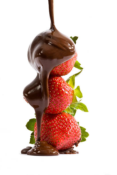 Three strawberries in a stack drizzled with chocolate stock photo