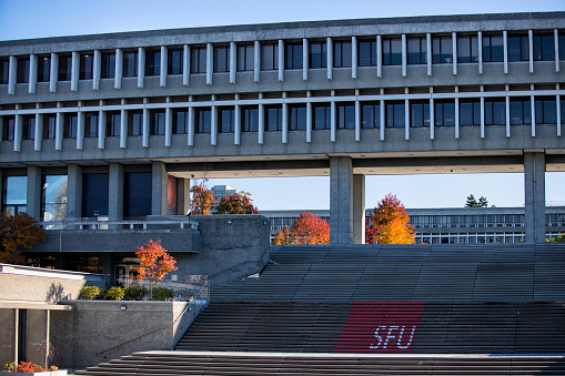 October 30, 2021, Student walking on the stairs with SFU sign at Simon Fraser University Campus, Burnaby, BC, Canada