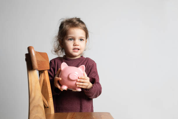 istock Child with Piggy Bank 1351714652