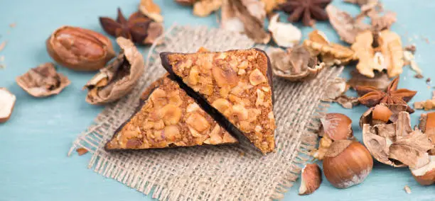 Nut corner, traditional german sweets called Nussecke, covered with chocolate, christmas baking