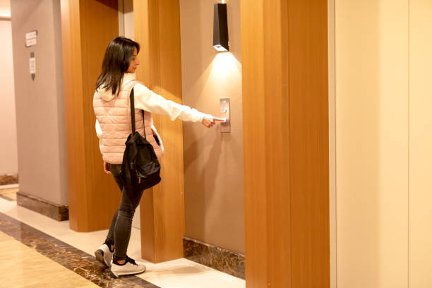 istock woman pressing the button of the elevator. 1351715610