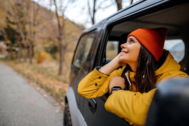 istock Woman on a road trip with car 1351716857