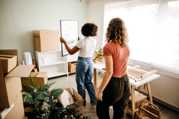 Our new home Roommates moving into a new home. Together they equip their space where they will live tenant stock pictures, royalty-free photos & images