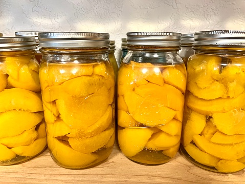 Shelf with jars of peaches