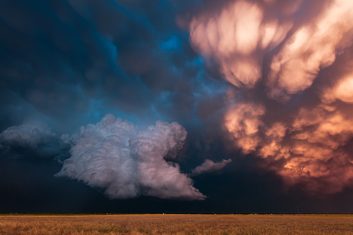 Stormy sunset sky with dramatic mammatus clouds over a field in Lubbock, Texas.