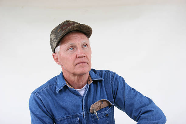 Grandpa wearing his ball cap posing in front of a white background.  Pocket flap up with pen, as usual.  