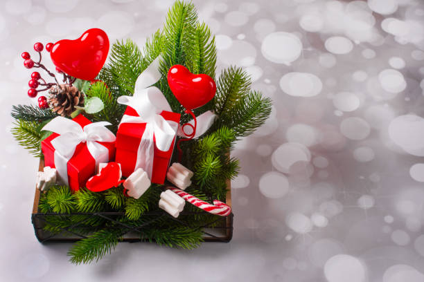 istock New Year gift basket. Green Christmas tree candy and gift boxes 1351742284