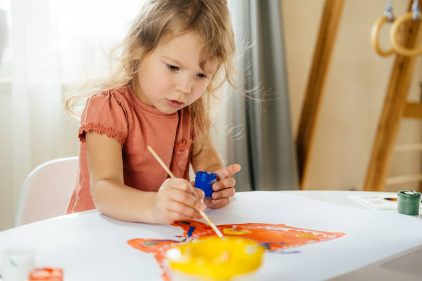 istock The girl drawing the paints. 1351744909