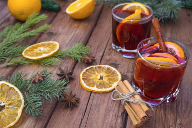 istock Mulled wine and spices on a wooden background with branches of a Christmas tree. Selective focus 1351745105