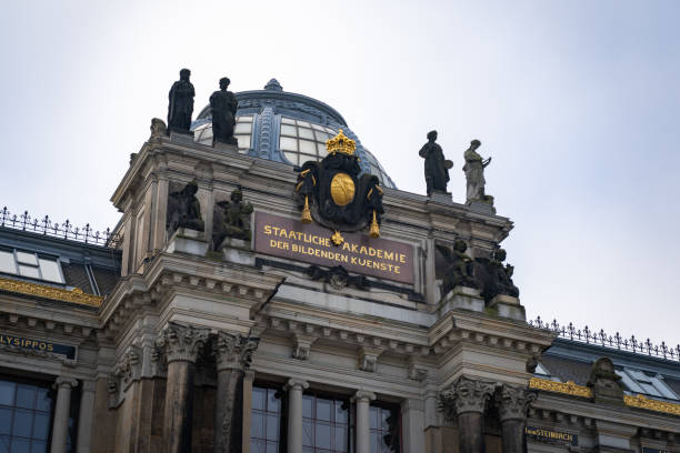 Dresden, Academy of Fine Arts in the old city. Beautiful historic architecture in Europe. Golden elements on the facade are shining. Big sculptures are visible.