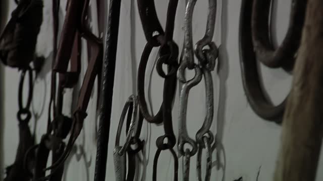 Vintage Horse Straps and Gaucho Riding Equipment hanging from a Wall in a Building in Argentina. Close Up.