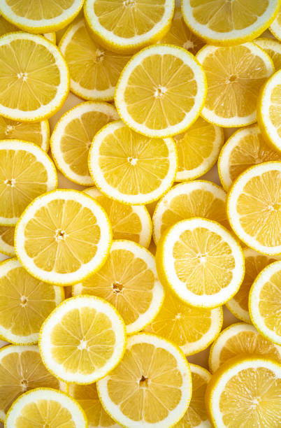 istock Lemon fruit slices arrangement in a row full frame background 1351746647