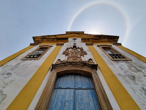 Facade of historic colonial style house and church in the famous city of Tiradentes in Minas Gerais, Brazil