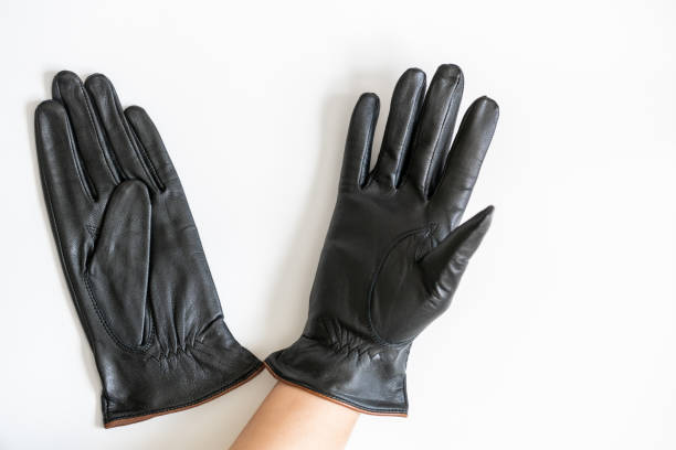 istock Black leather gloves  on white background 1351751520