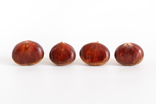 Fresh sweet chestnuts. Roasted chestnuts. On white background