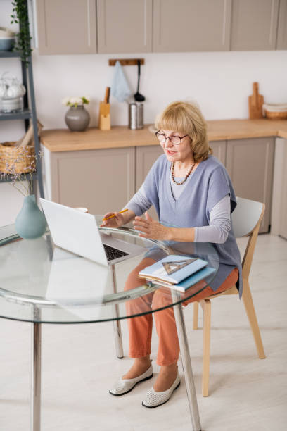 istock Confident mature woman communicating in video chat 1351753225