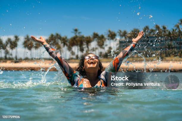Woman Bathing With Splash On Beach Stock Photo - Download Image Now - Vacations, Solo Travel, Tropical Climate