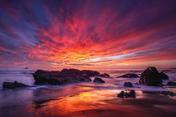 Crystal Cove State Park - Sky Fire Hands down one of the most intense sunsets I have ever experienced. The moderate tide that washed through the uniquely carved and sculpted rocks at this unusual Southern California beach really showcased the drama of the flow and movement and exquisite beauty that unfolded on this October evening. awe stock pictures, royalty-free photos & images