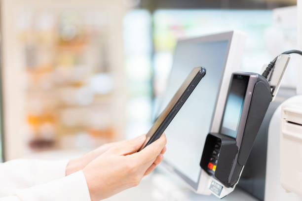 istock Young woman using self-checkout and e-money payment 1351767363