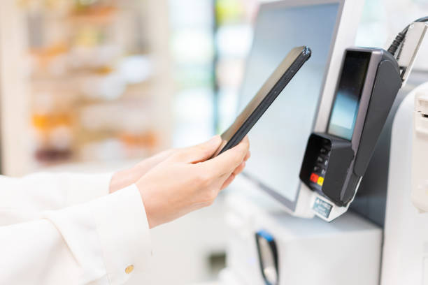 istock Young woman using self-checkout and e-money payment 1351767364