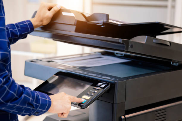 istock Businessmen press button on the panel for using photocopier or printer for printout and scanning document paper at office. 1351772915