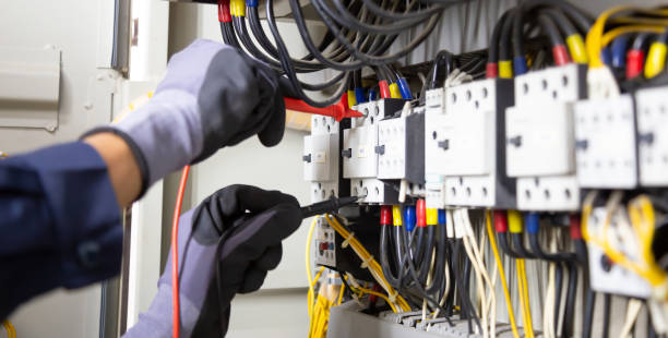 istock Electrician engineer tests electrical installations and wires on relay protection system. Adjustment of scheme of automation and control of electrical equipment. 1351772959