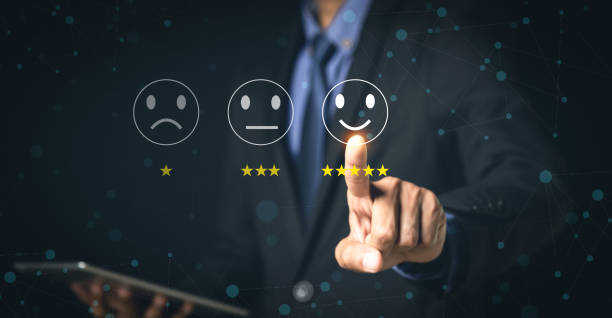 istock Customer Service and Satisfaction Concept Businessmen touch the virtual screen on happy smiley icons to achieve service satisfaction and feedback with excellent rated reviews. 1351772979