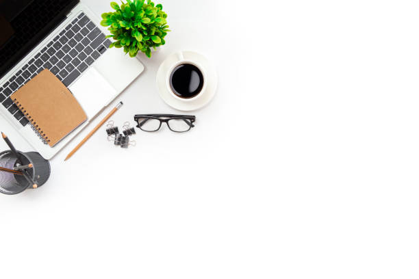 istock White office desk table with blank notebook, computer keyboard and other office supplies. Top view with copy space, flat lay. 1351773022