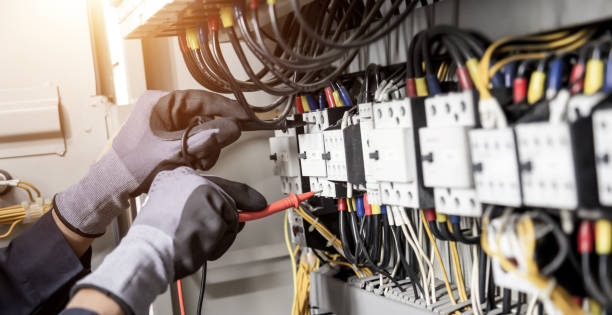 istock Electrician engineer tests electrical installations and wires on relay protection system. Adjustment of scheme of automation and control of electrical equipment. 1351773029