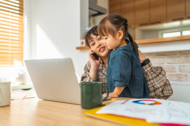 istock Mother trying to talk on phone while her small daughter interrupts her 1351774644