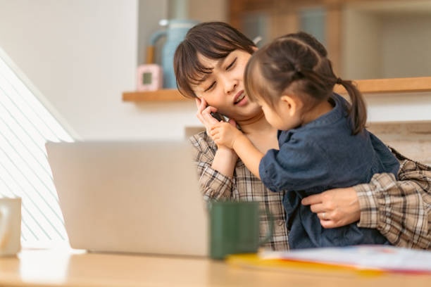 istock Mother trying to talk on phone while her small daughter interrupts her 1351774735