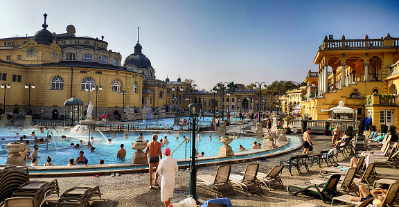 Large group of people at outdoor pool in Széchenyi Thermal Bath in Budapest, Hungary
