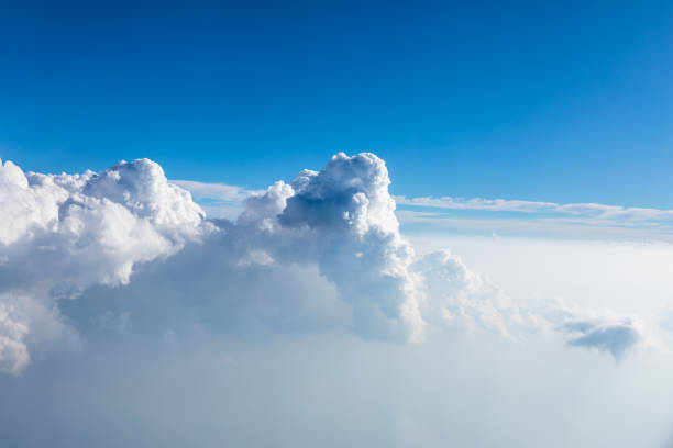 istock Clouds and sky as seen through window of an aircraft 1351776349