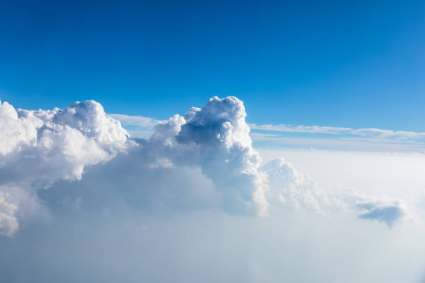 Clouds and sky as seen through window of an aircraft stock photo