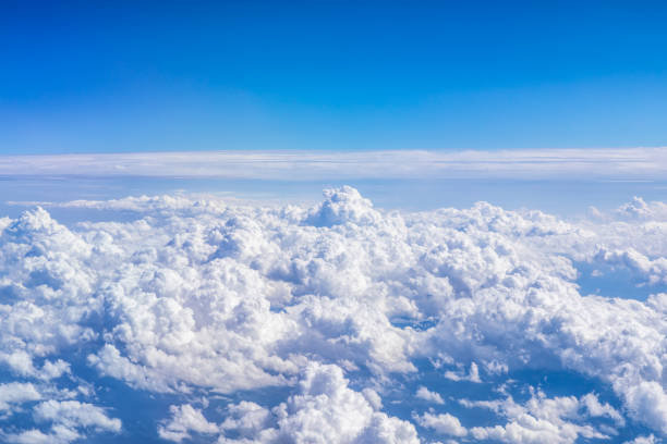 istock Clouds and sky as seen through window of an aircraft 1351776353